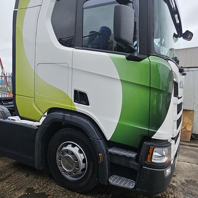 White truck cab featuring a vibrant custom vehicle wrap design.